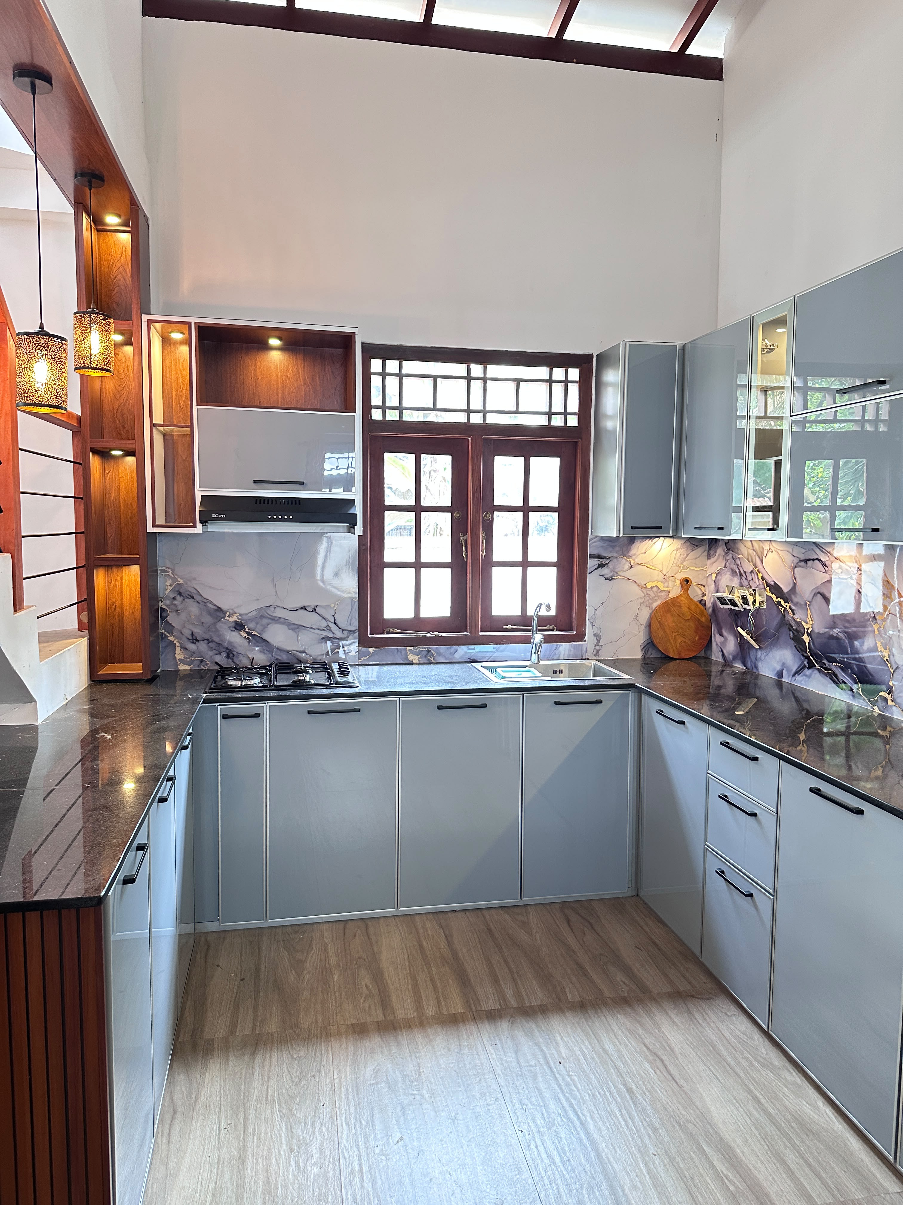 Grey kitchen cabinets with marble backsplash